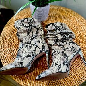 Schutz. New never worn. Size 7.5B. Snake pattern. Leather sole. Calf boots